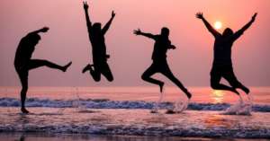 Teens jumping at beach